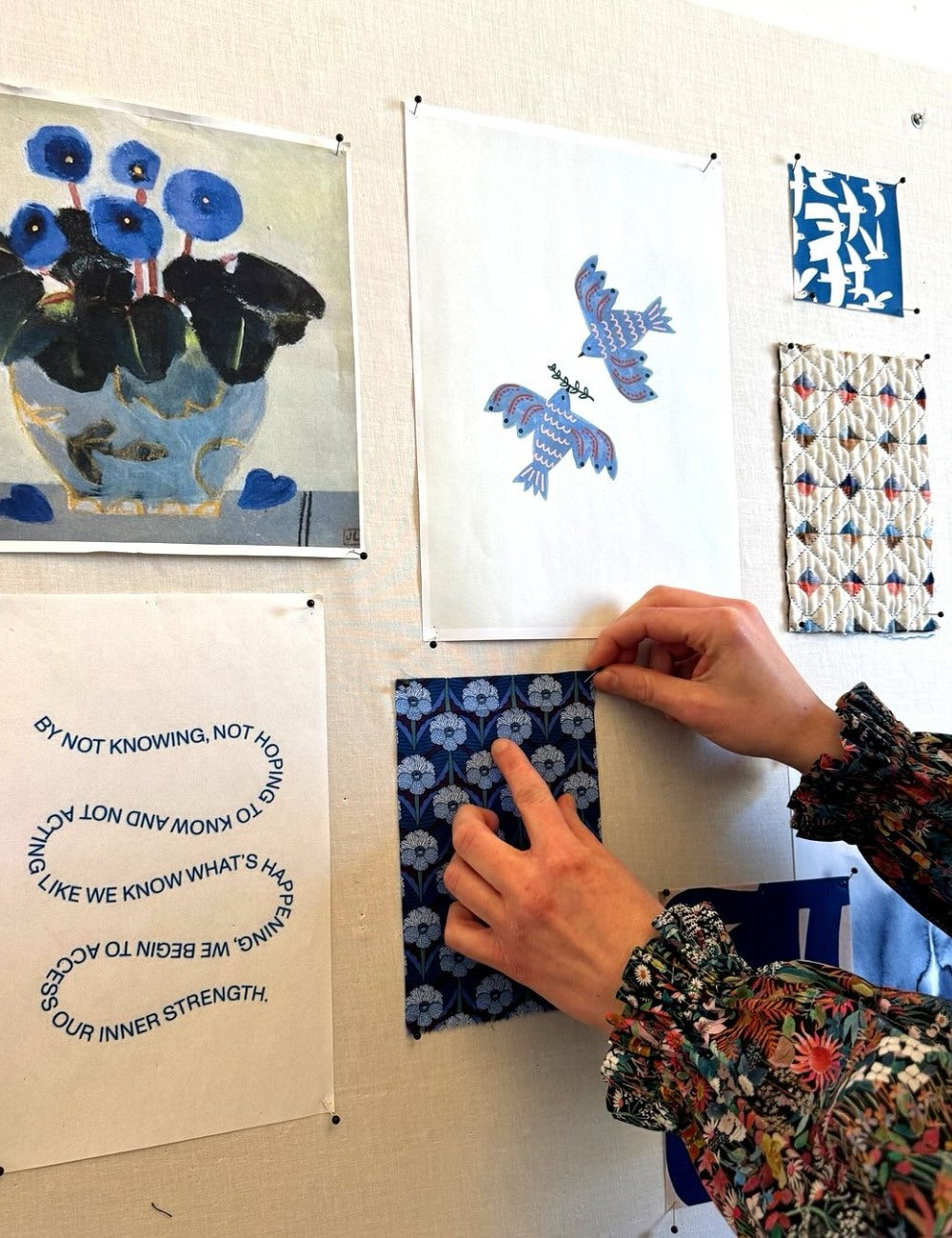 Collage of fabric swatches with blue and black floral patterns.