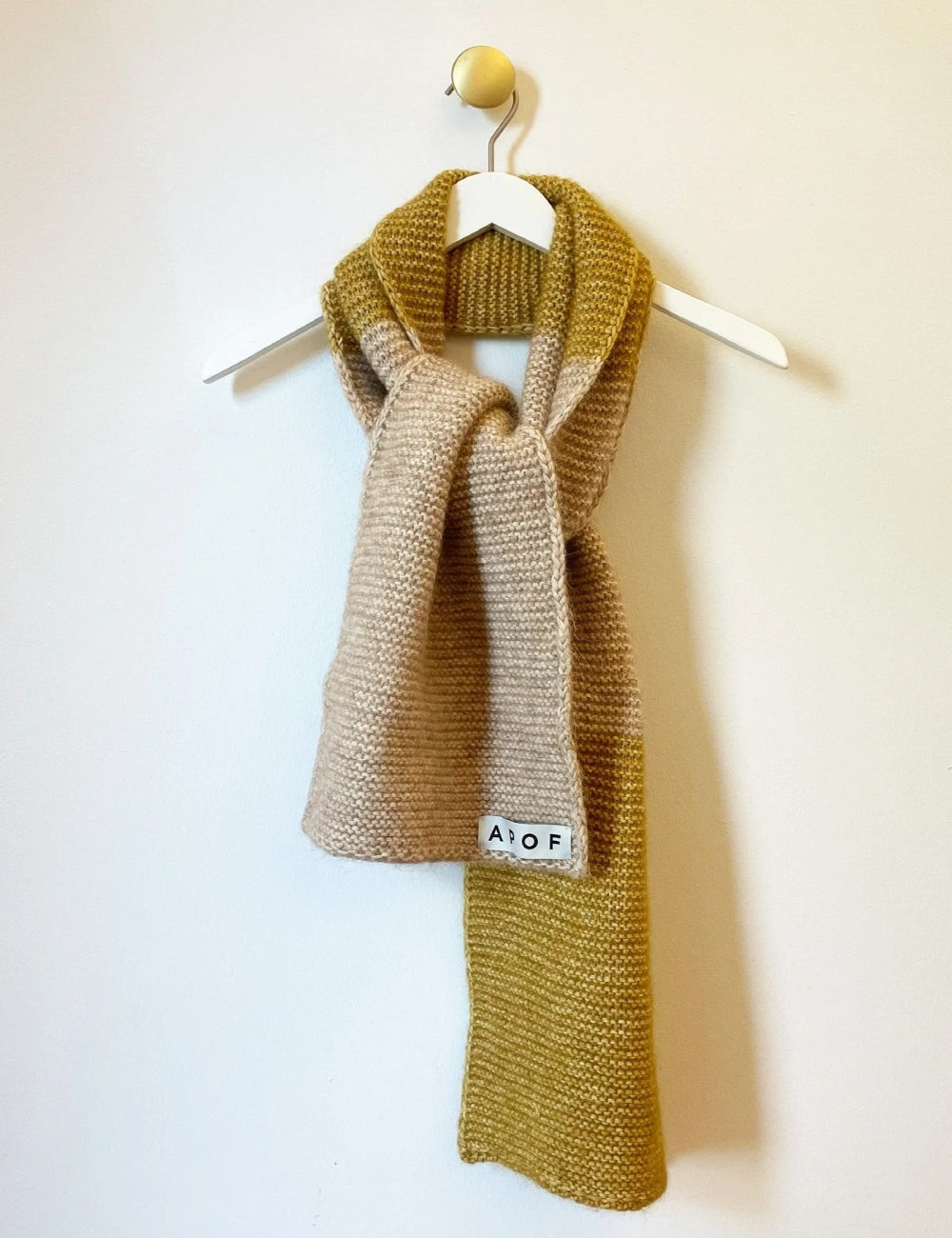 Women' long wool scarf in beige and sauterne color and APOF tag on hanger