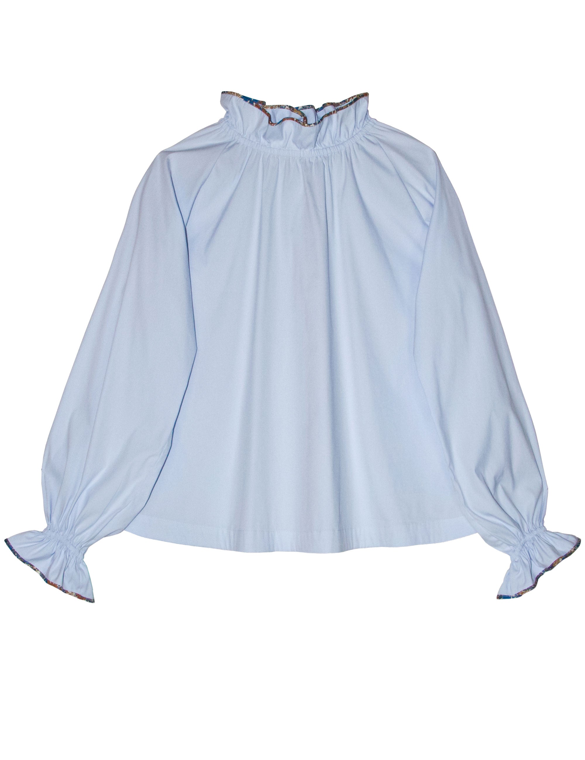 Long sleeve women's shirt in light blue cotton fabric with floral pipings and ruffled collar and  cuffs