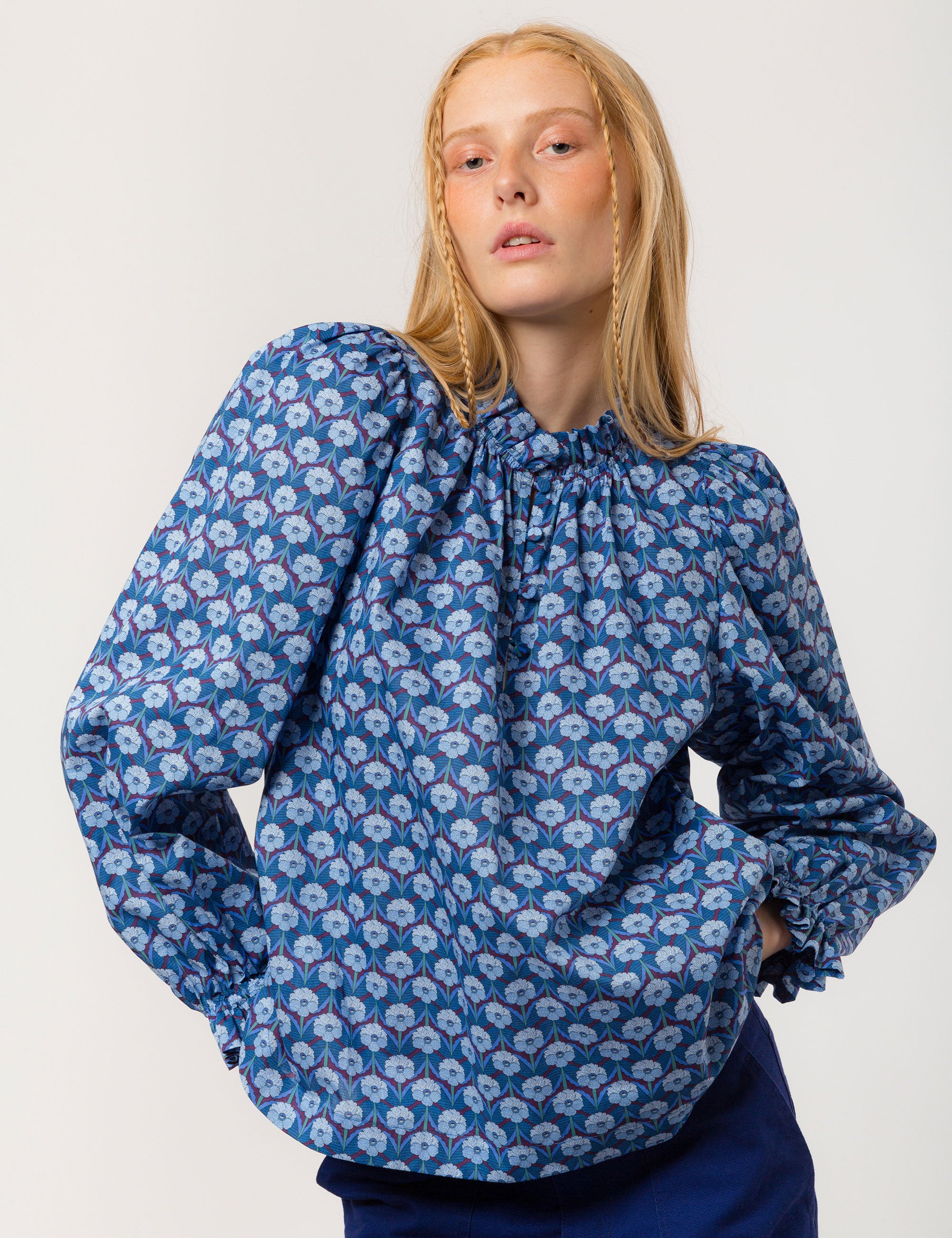 Woman in liberty cotton blue floral print shirt with frilled cuffs and collar