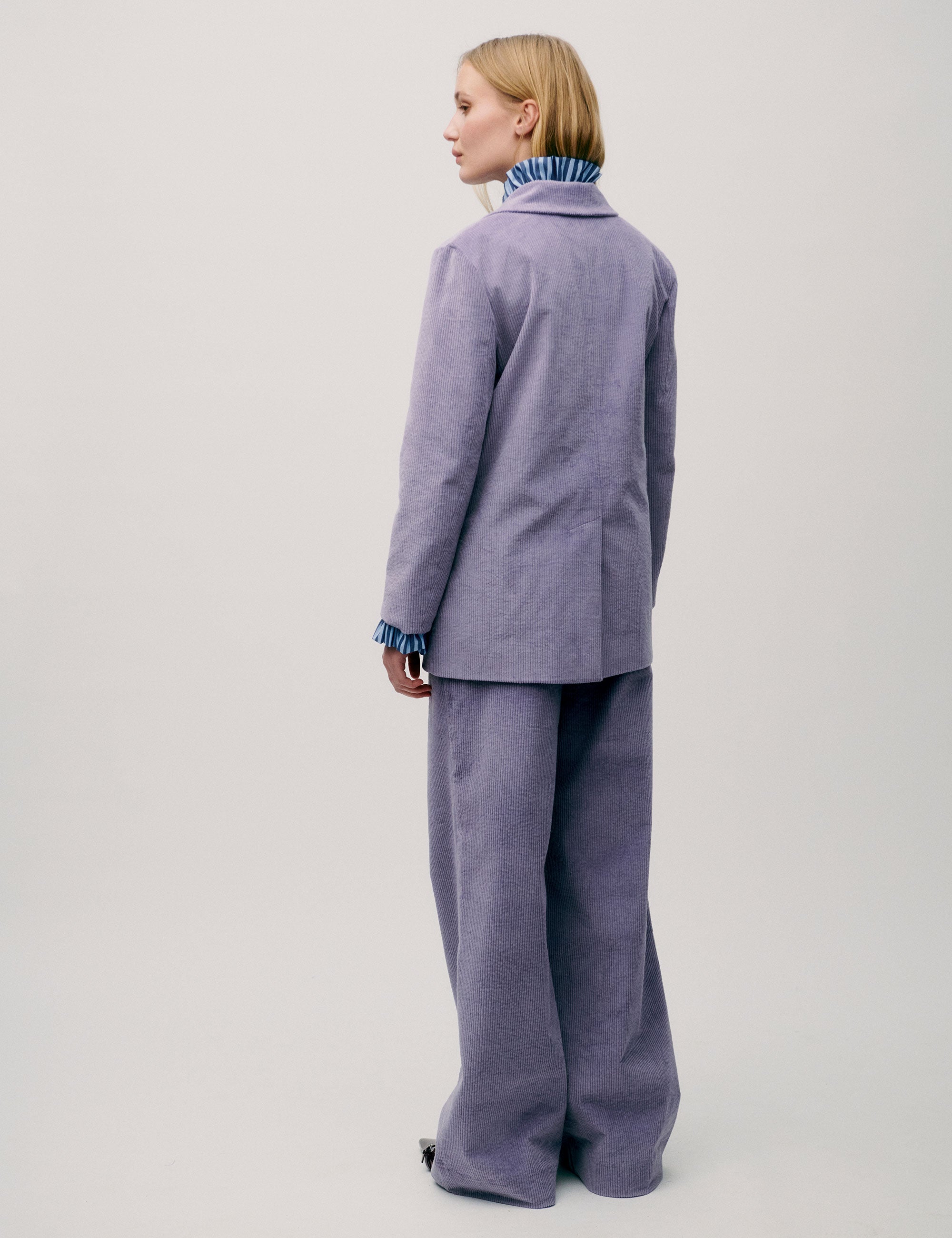 Back view of lilac corduroy blazer paired with matching trousers