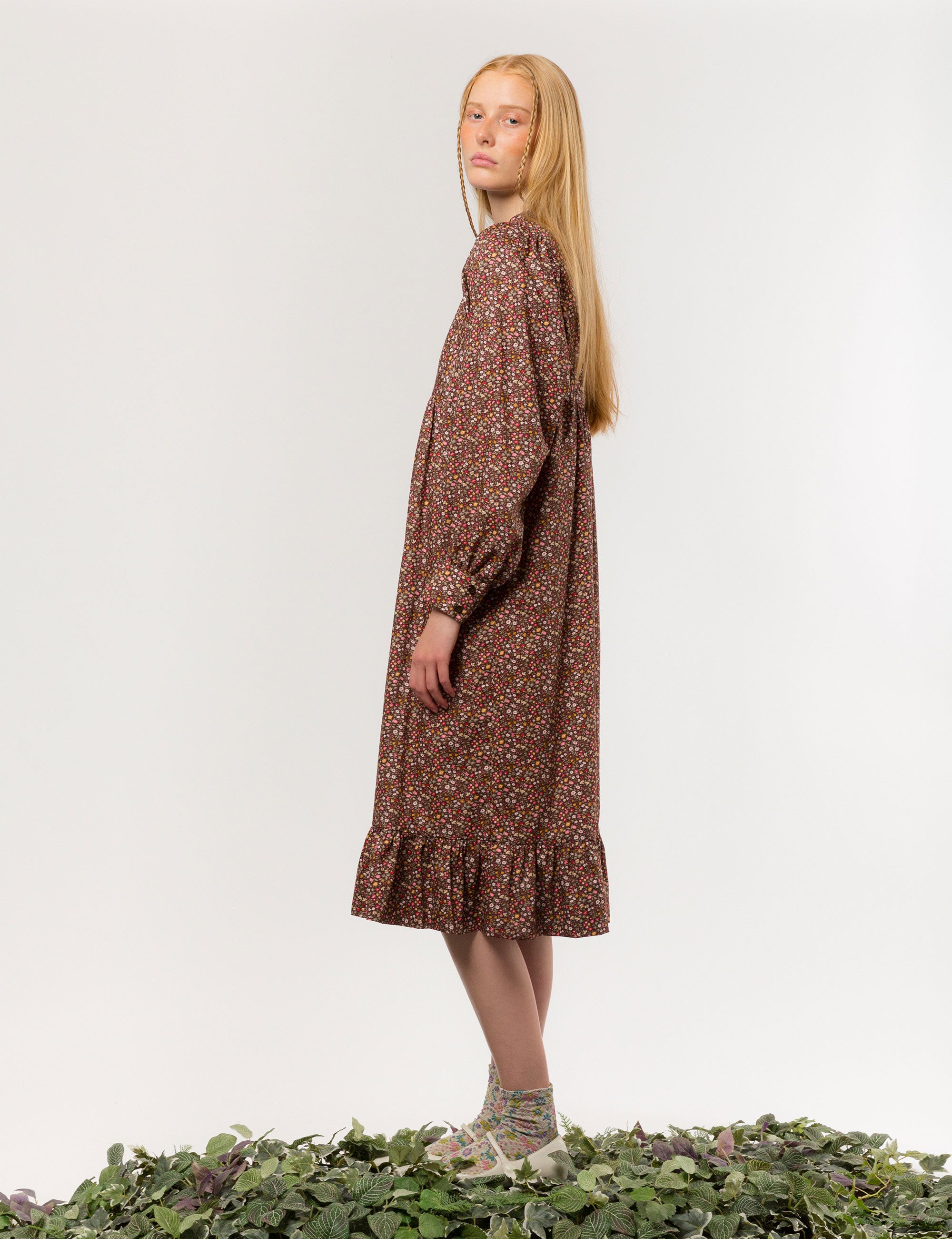 Woman in liberty cotton brown floral print midi dress with long sleeves and buttons