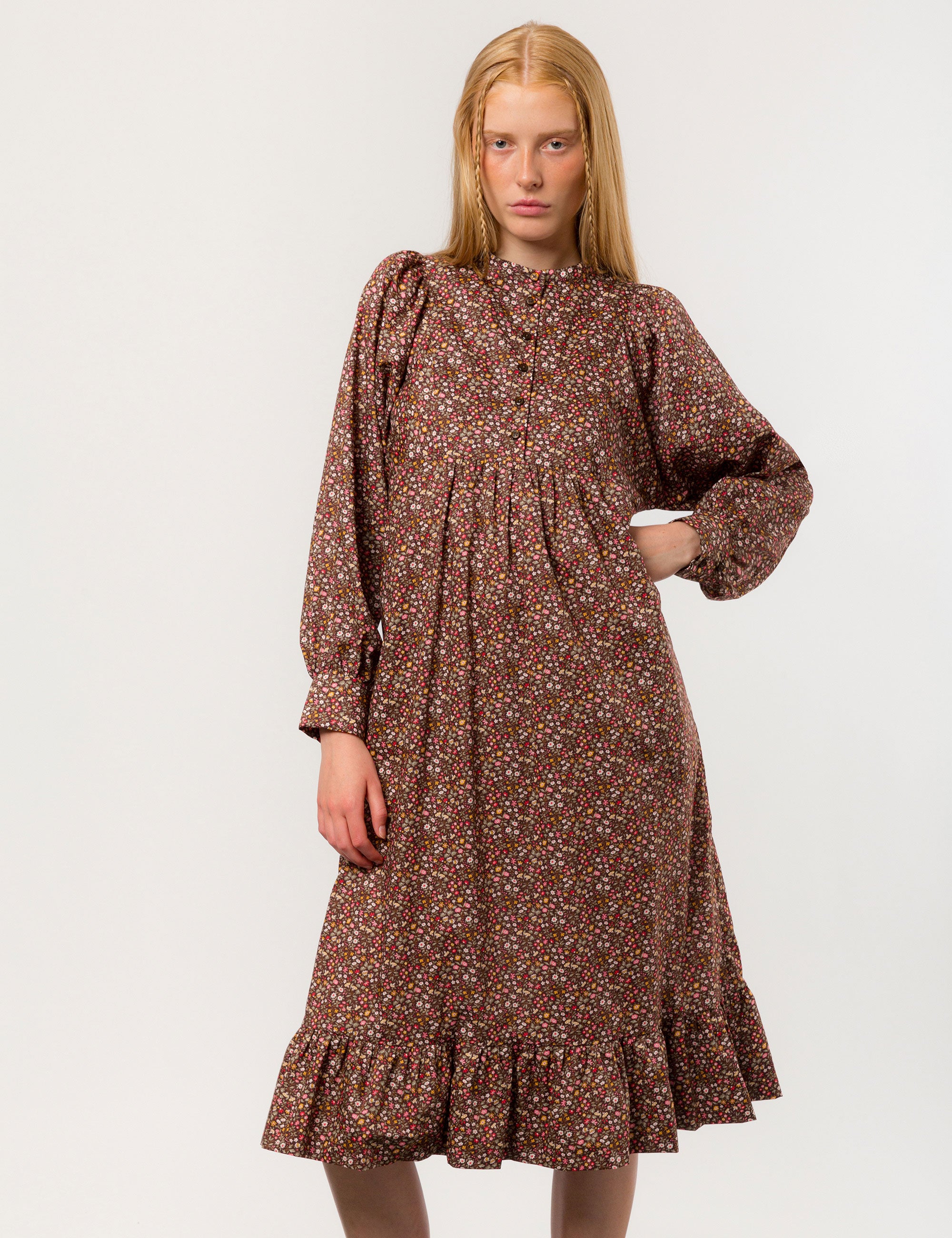 Woman in liberty cotton brown floral print midi dress with long sleeves and buttons