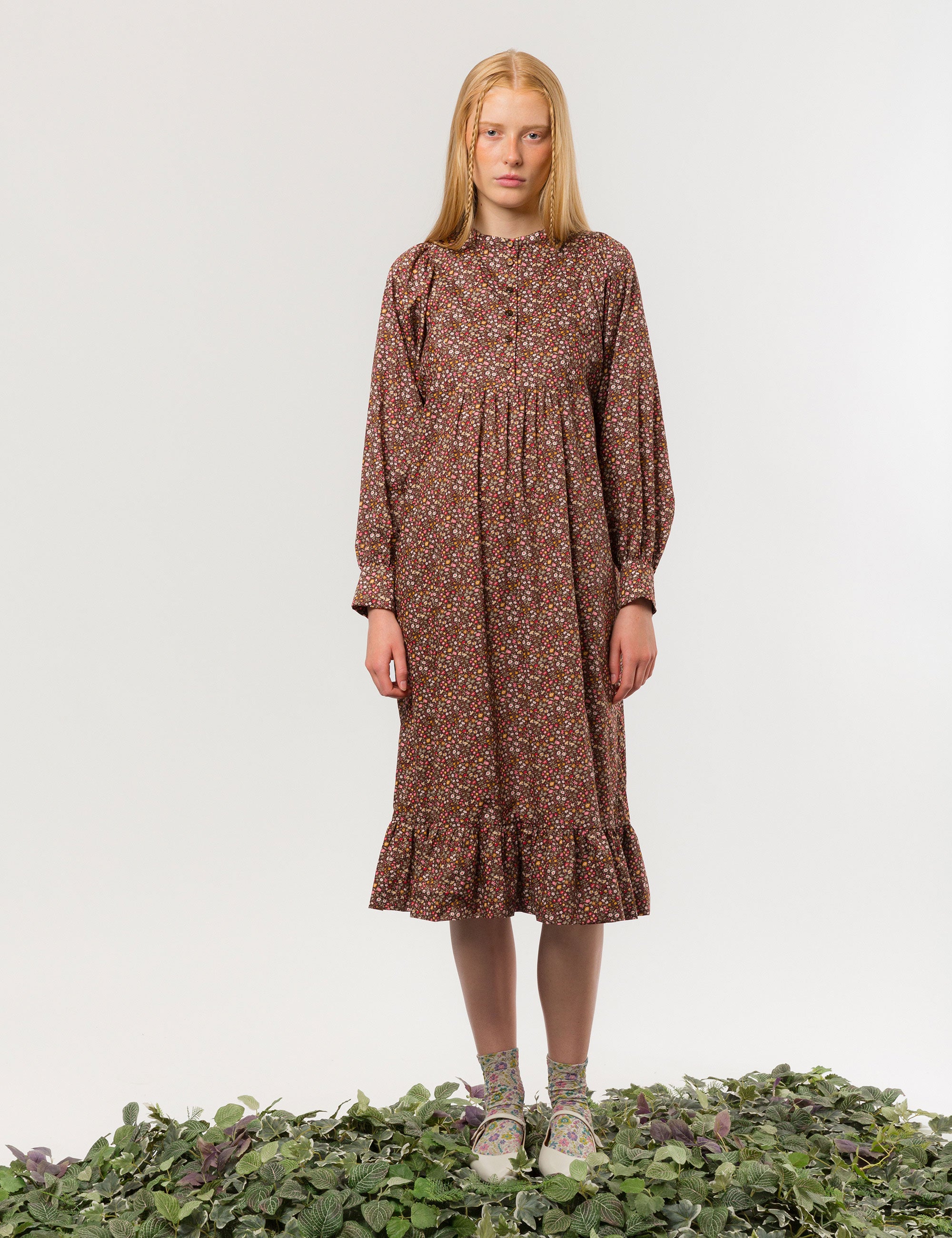 Woman in liberty cotton brown floral print midi dress with long sleeves and buttons