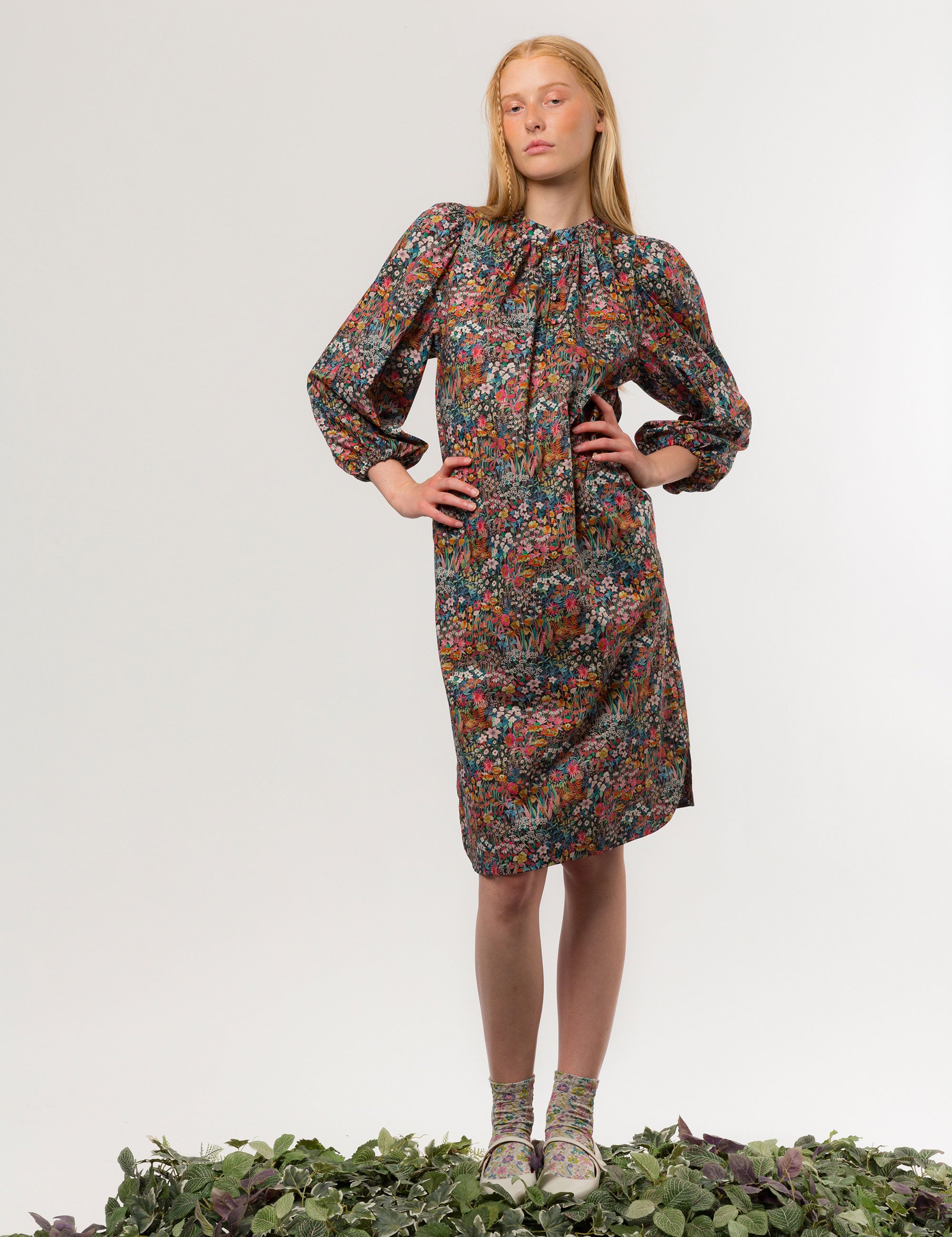 Woman in multi-colored floral print midi dress in premium liberty cotton with long puff sleeves