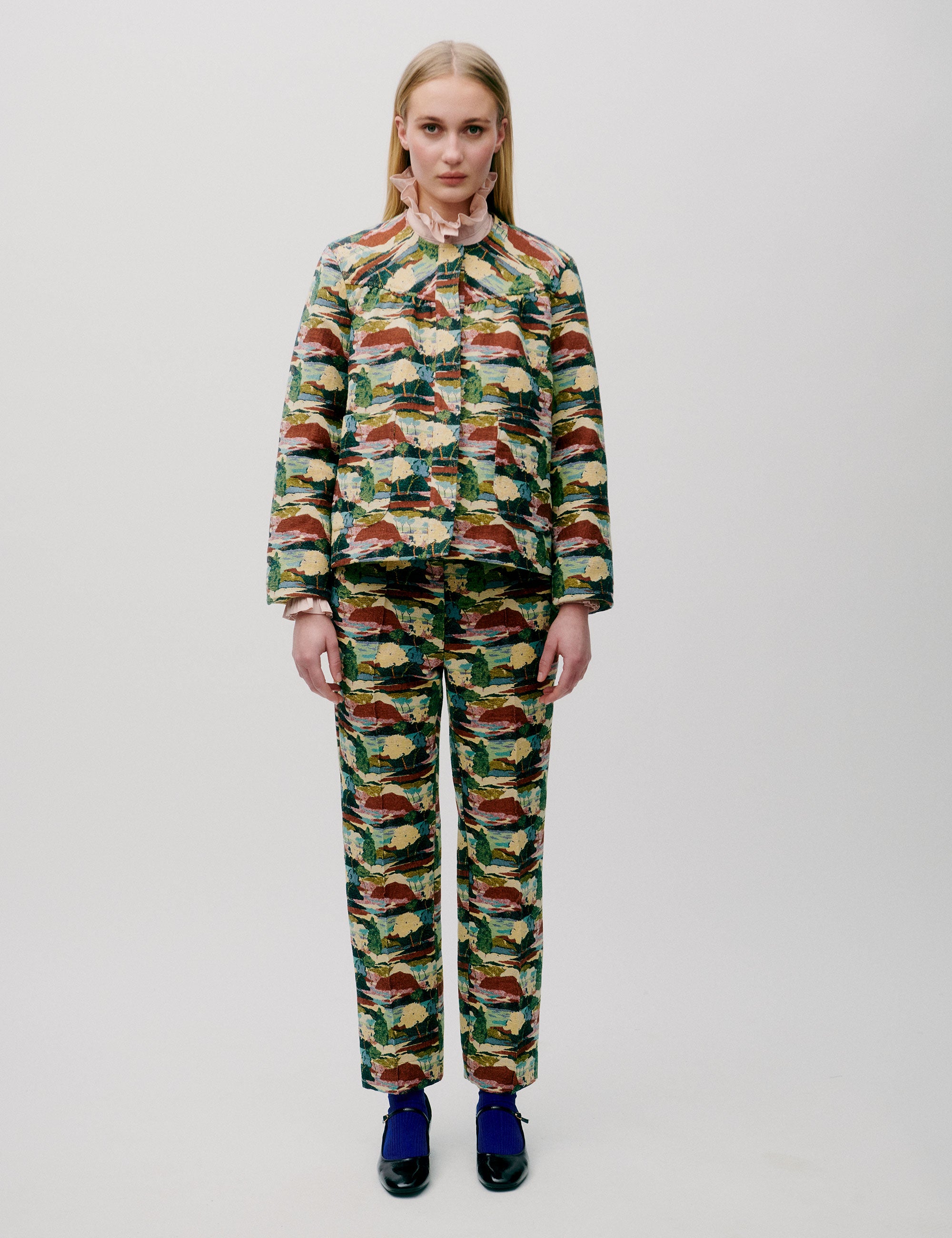 Woman in straight pants and jacket with artistic forest print