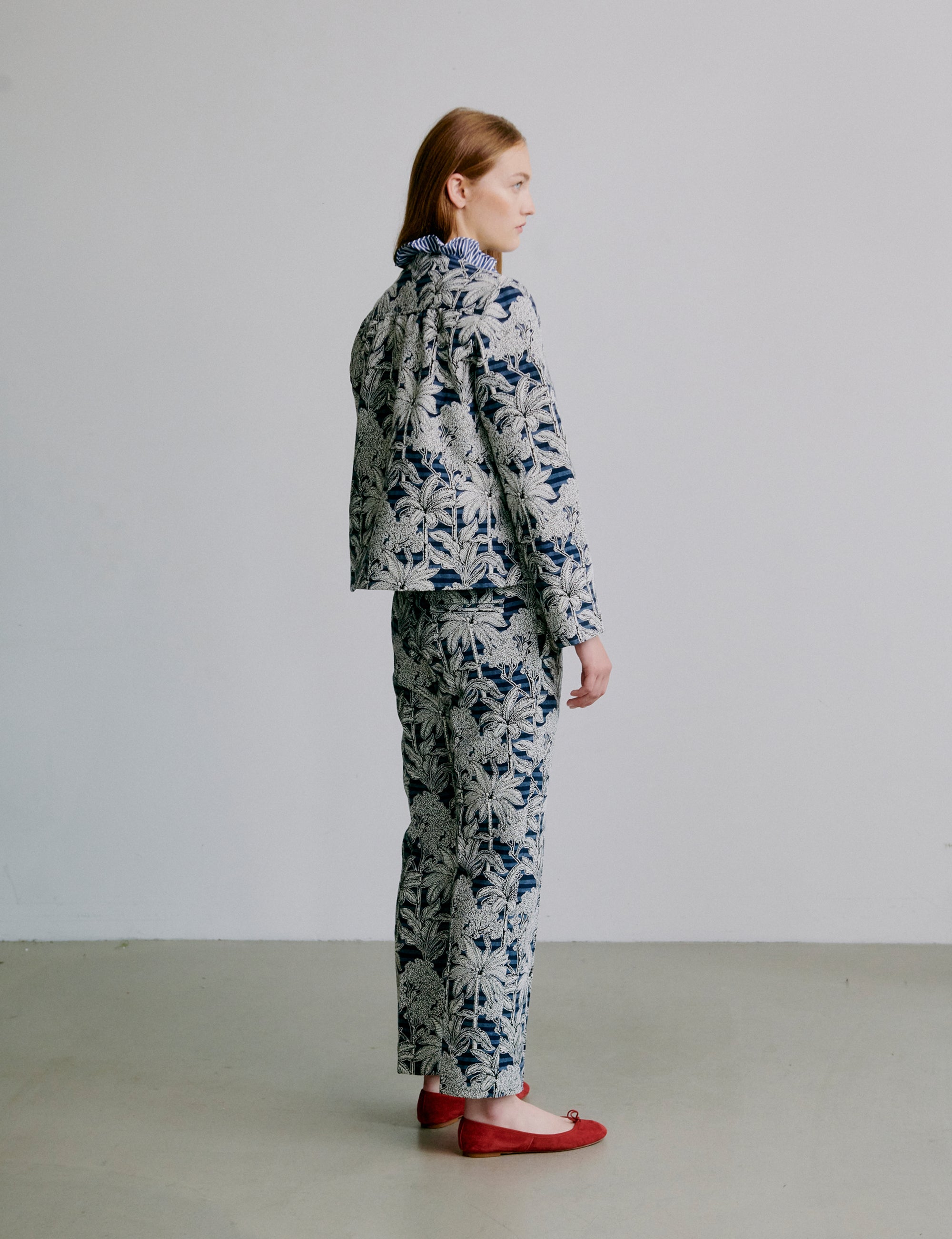 Person wearing a blue floral outfit - jacket and pants