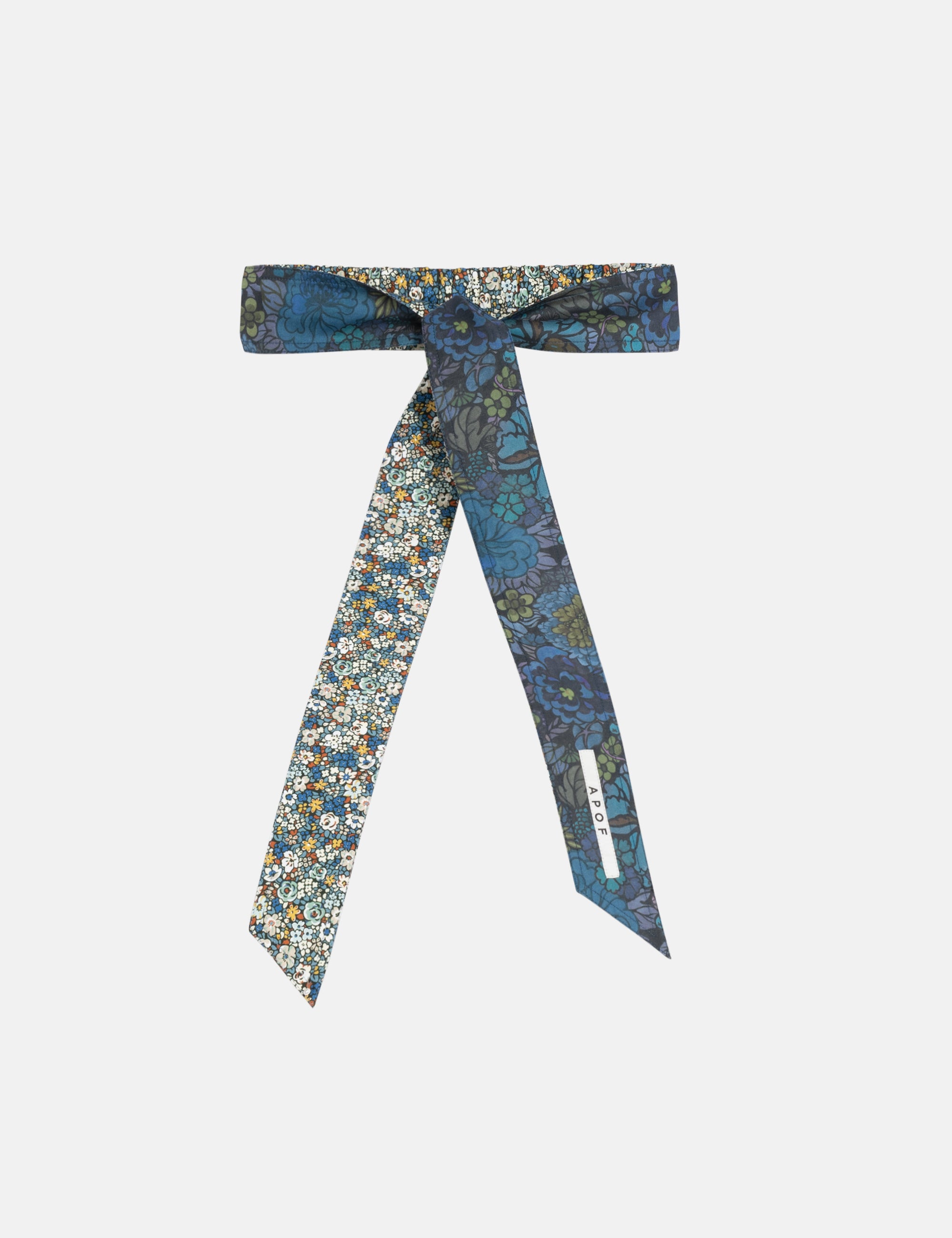 Green and blue floral patterned fabric belt on a white background