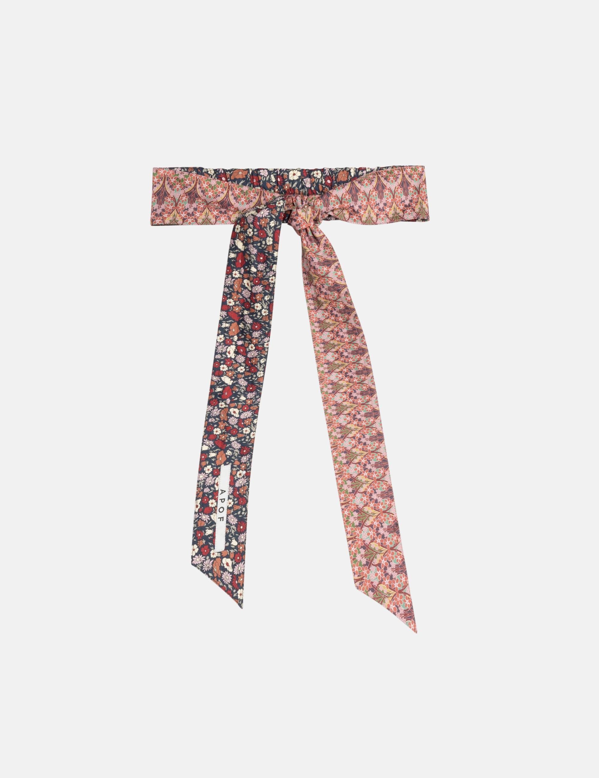Floral patterned cotton belt tied into a bow on a white background