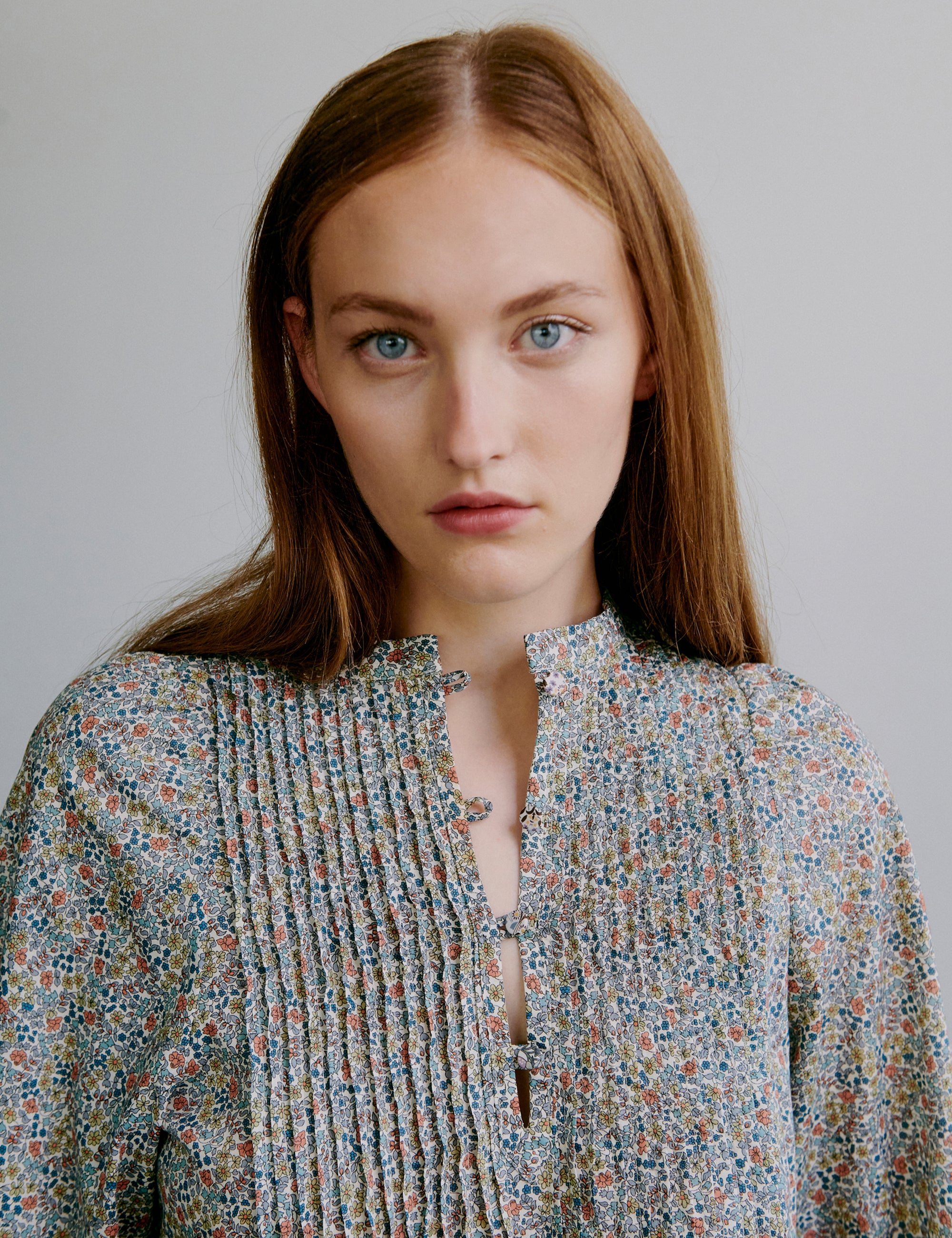 Woman wearing a floral patterned dress with buttons at the front