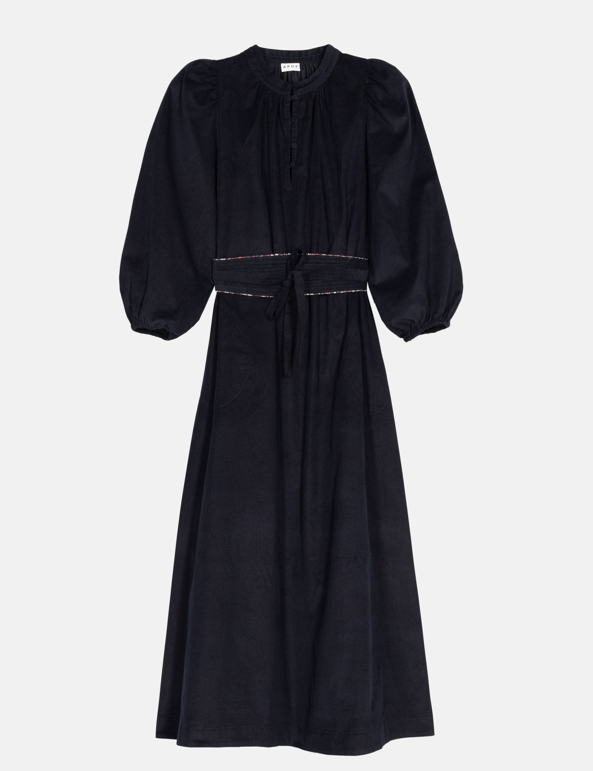 Navy blue maxi dress in baby corduroy with puff sleeves and matching belt on a light gray background