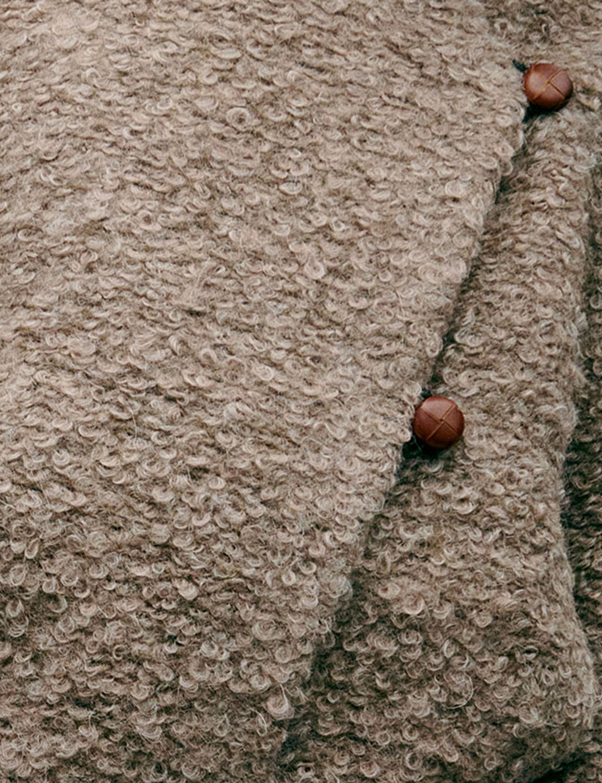 Close-up of wool fabric with brown buttons