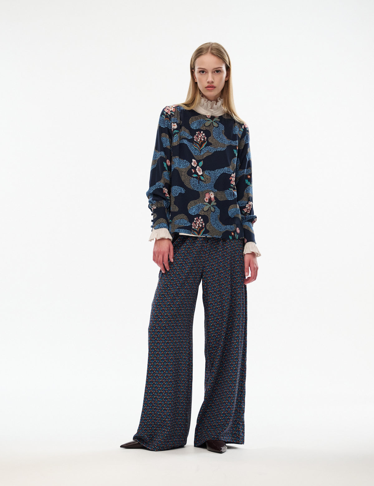 Printed long-sleeve blouse in dark navy with multicolor floral and butterfly motifs, front view