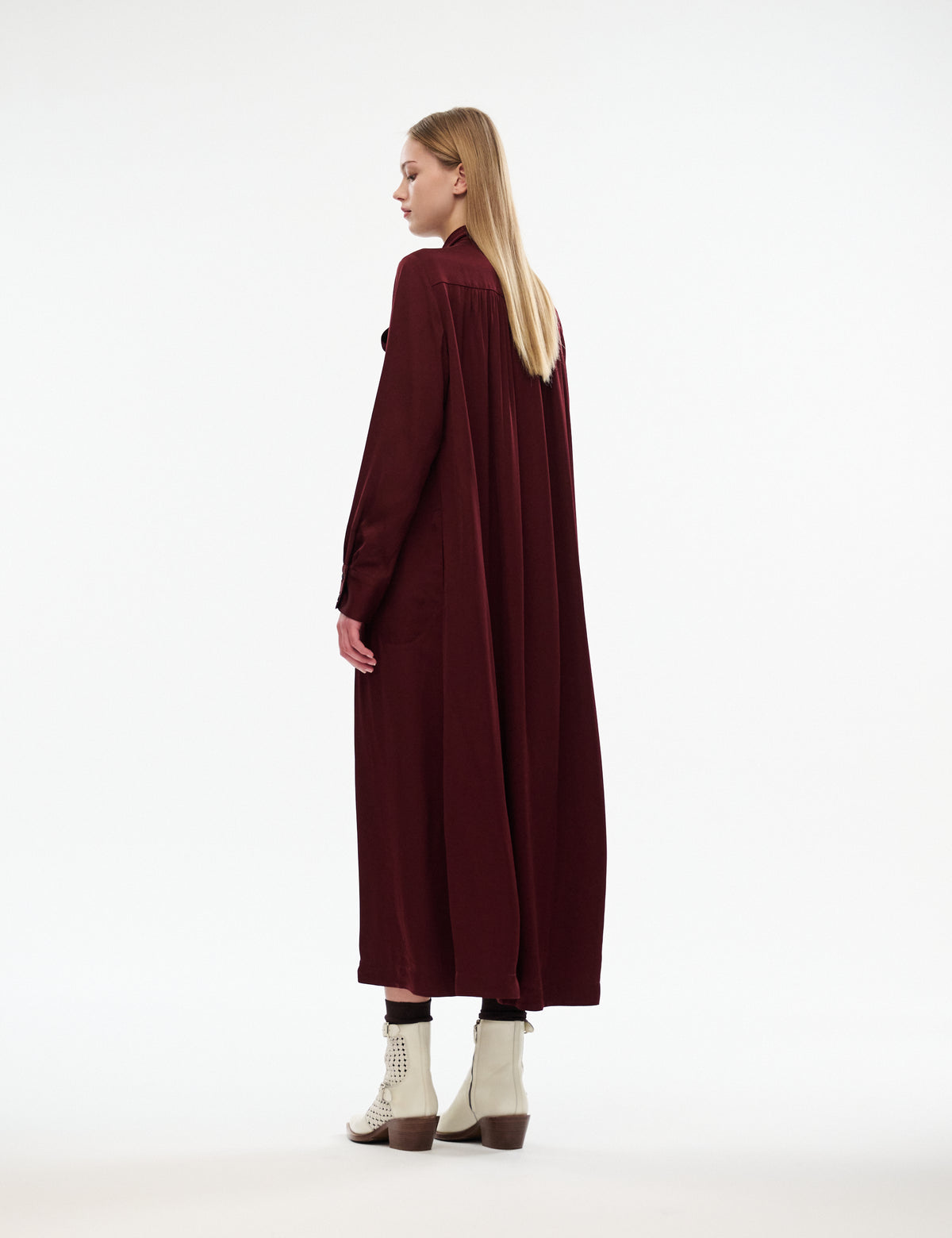 Burgundy midi dress with long sleeves, draped back silhouette, side-back view