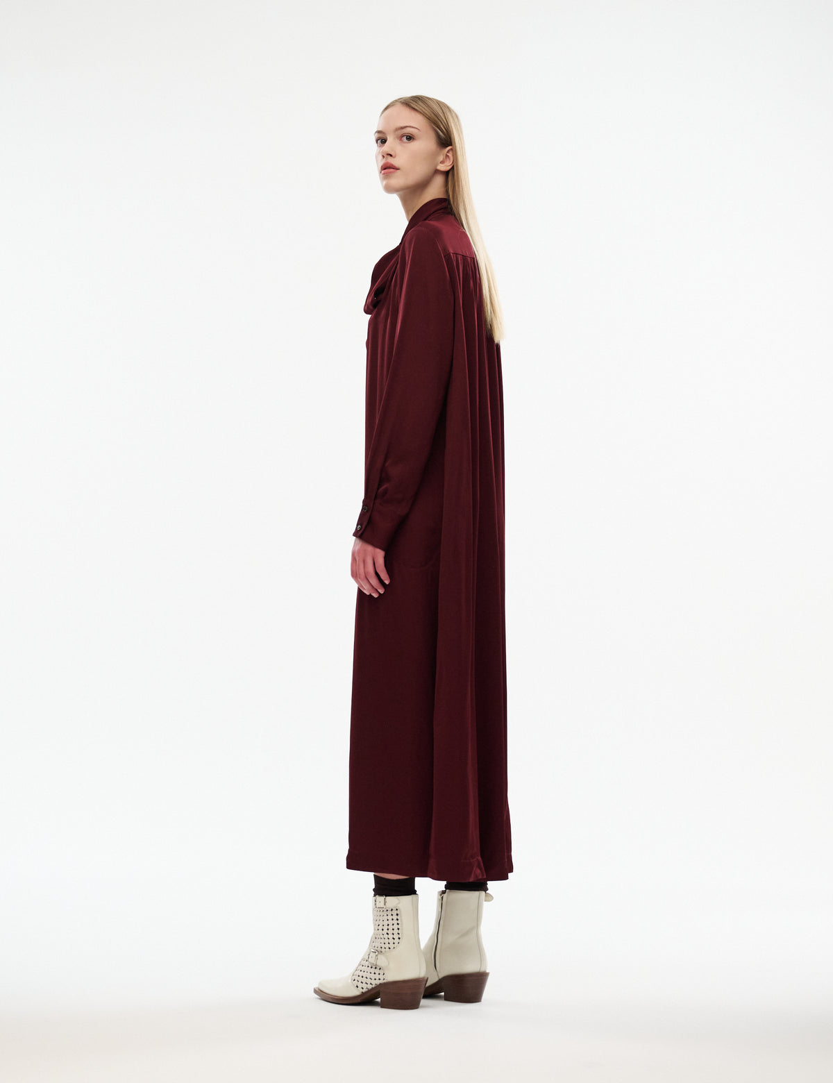 Burgundy midi dress, long sleeves and tied neck bow, side view
