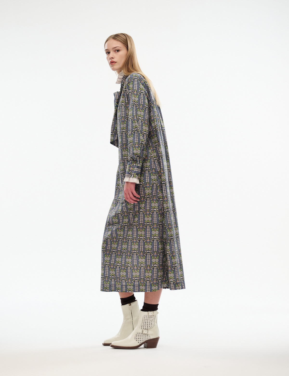 Mira dress side profile with long sleeves and midi hem; dark floral-patterned fabric