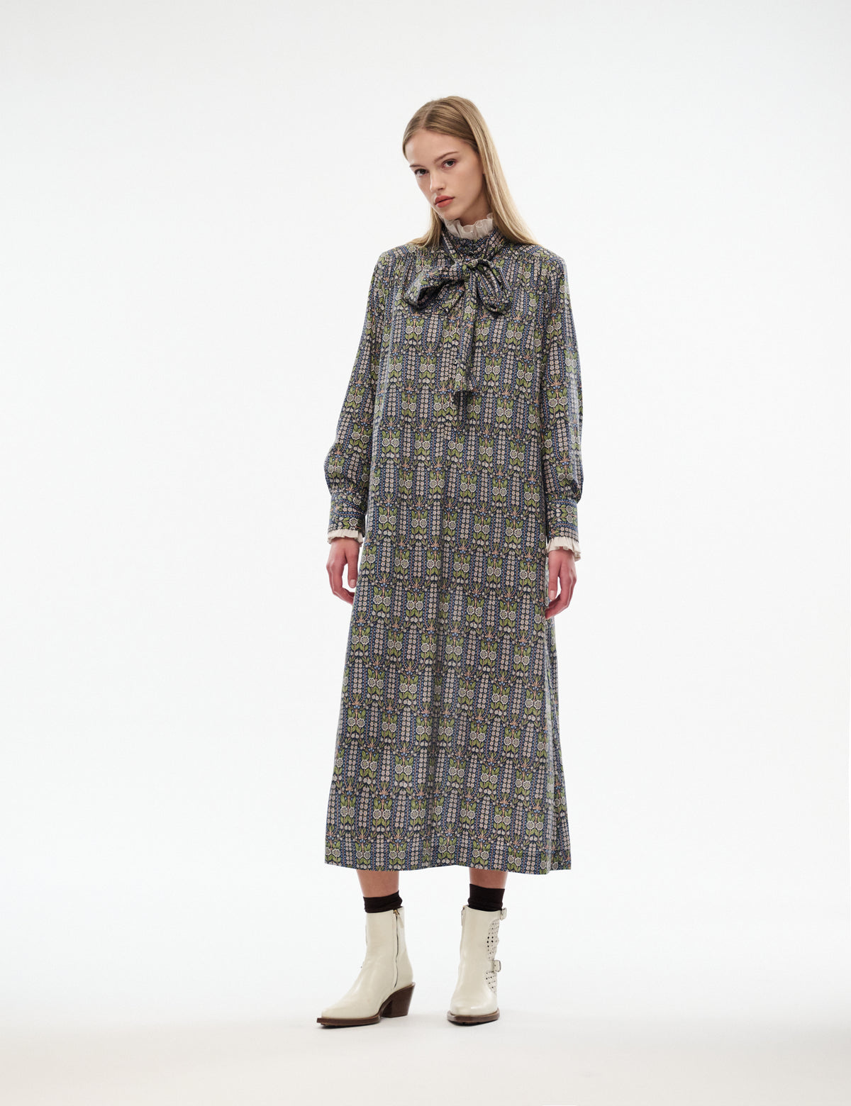 Mira dress with ruffled bow neck, long sleeves, midi length; dark patterned fabric in green/yellow