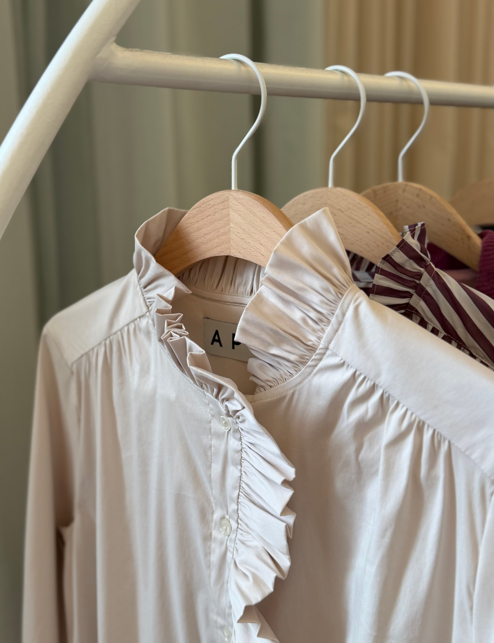 Rack with women's shirts with ruffled collars