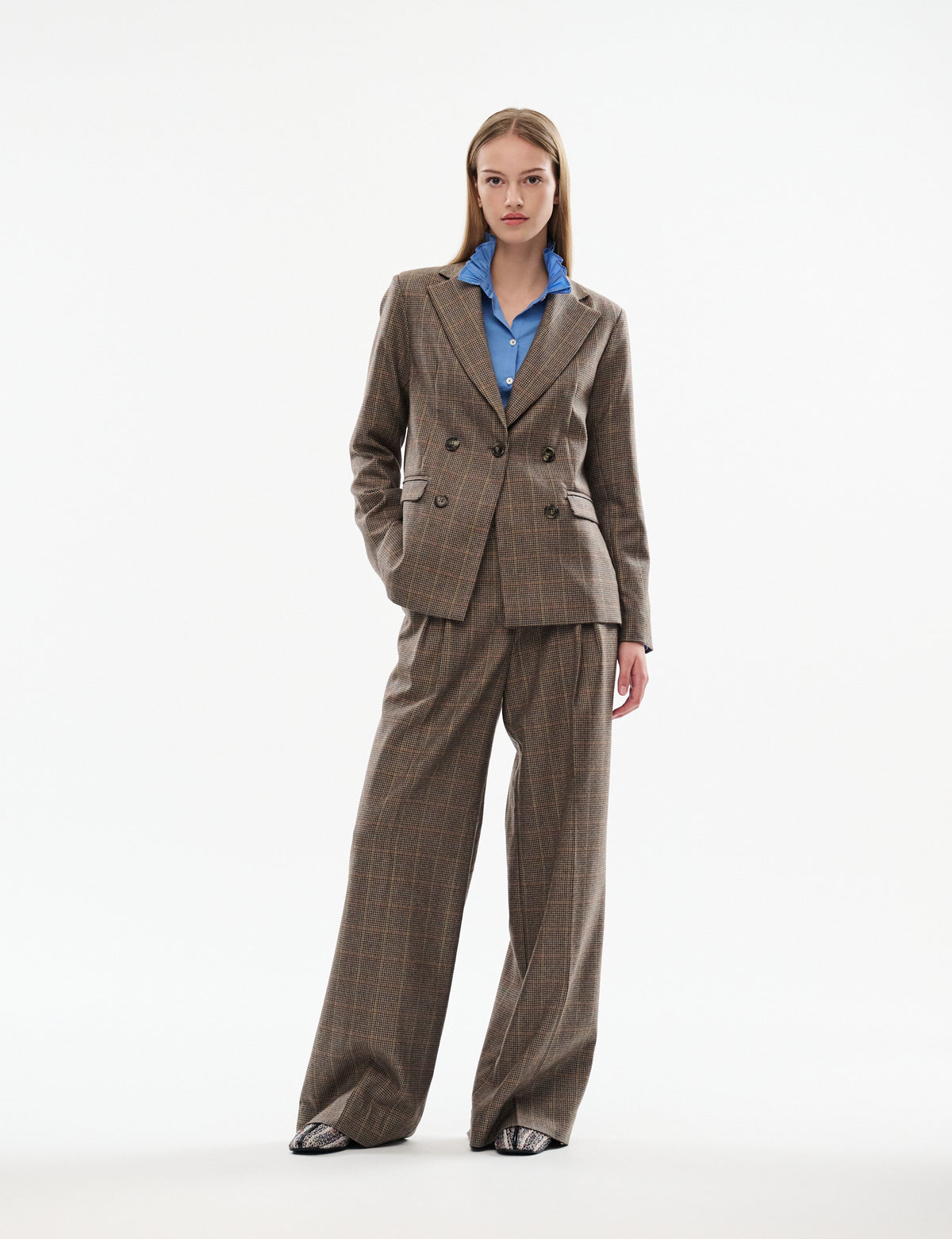Brown plaid pants with wide, flowing legs and a high-waist waistband